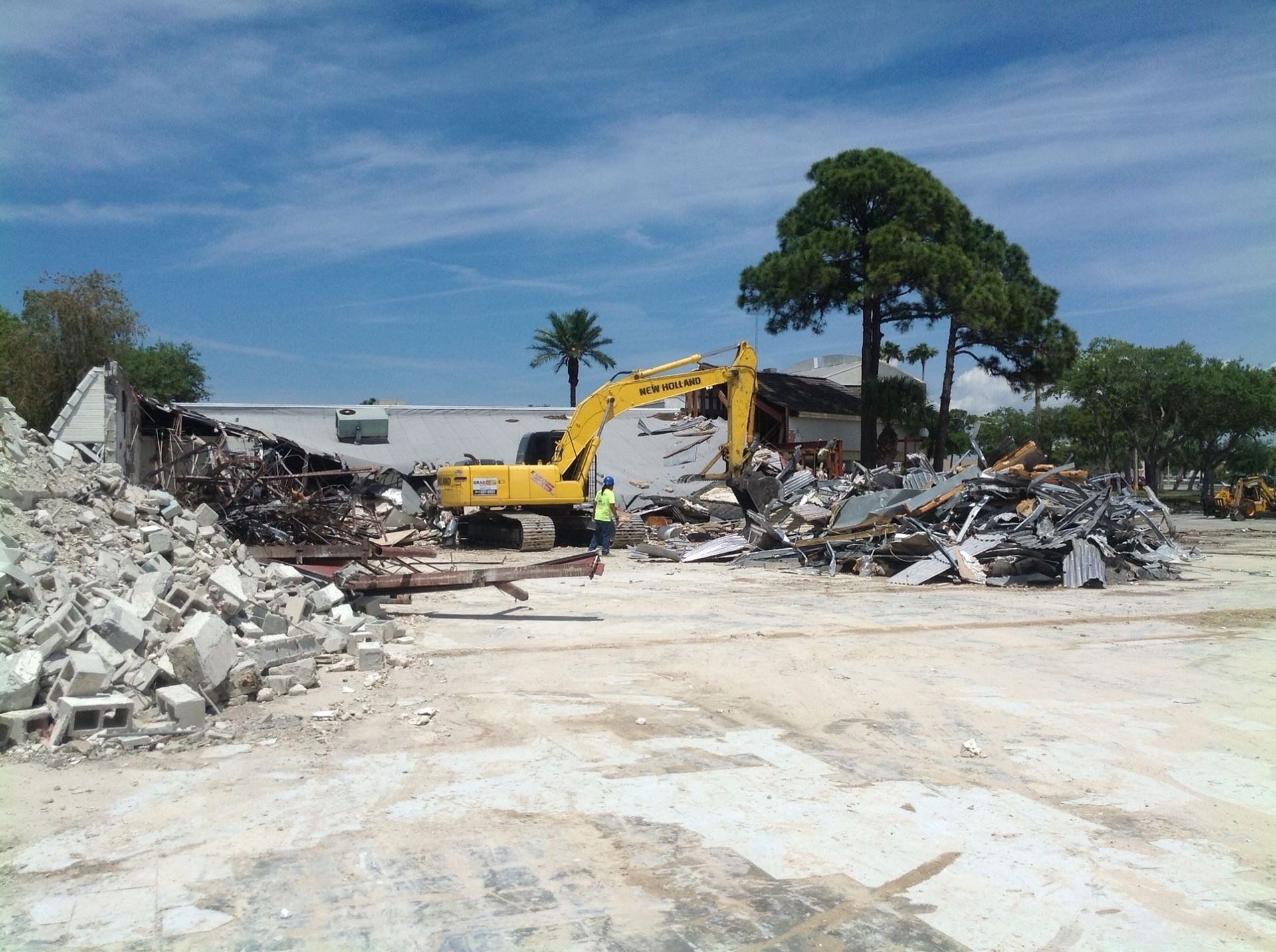A bulldozer is destroying a building on a construction site.