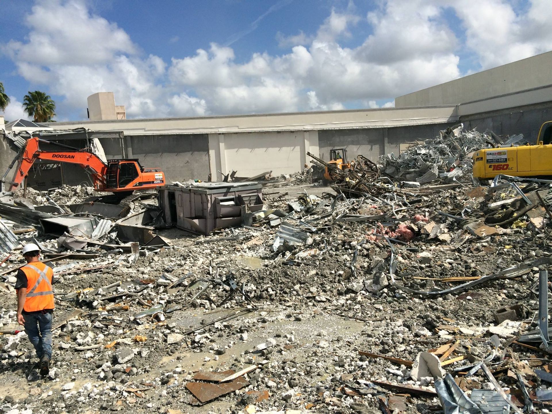 An excavator is demolishing a building in a city.