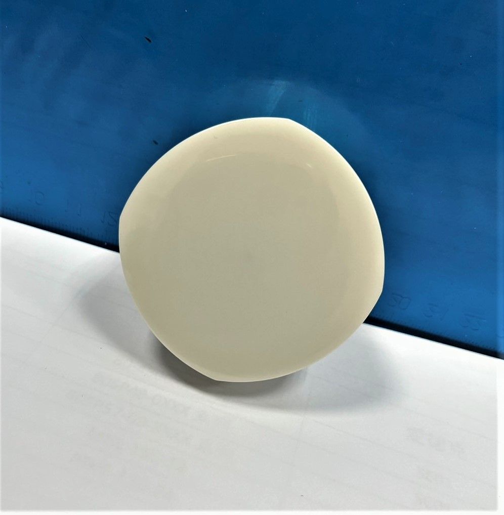 A white circle is sitting on a white surface with a blue background