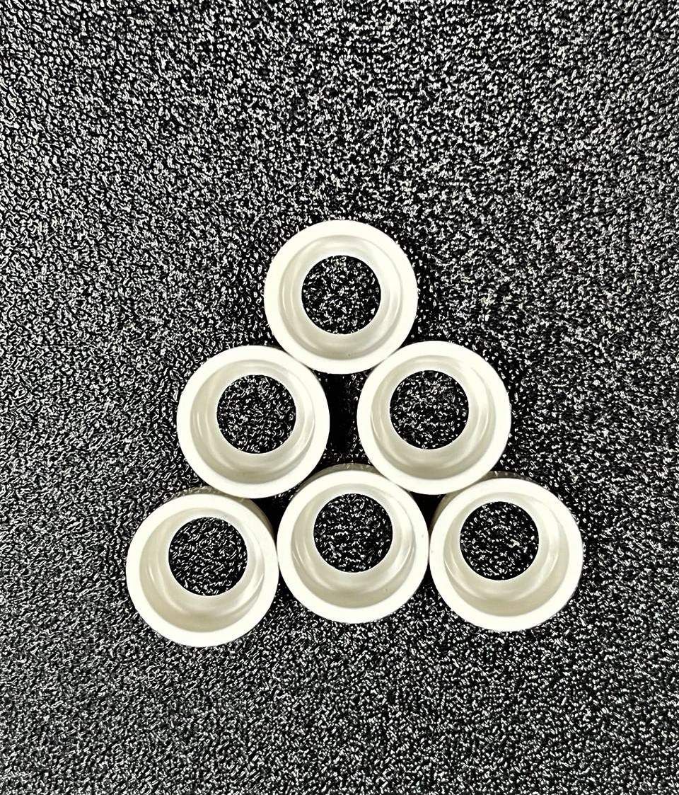 A stack of white circles sitting on top of each other on a gray surface.