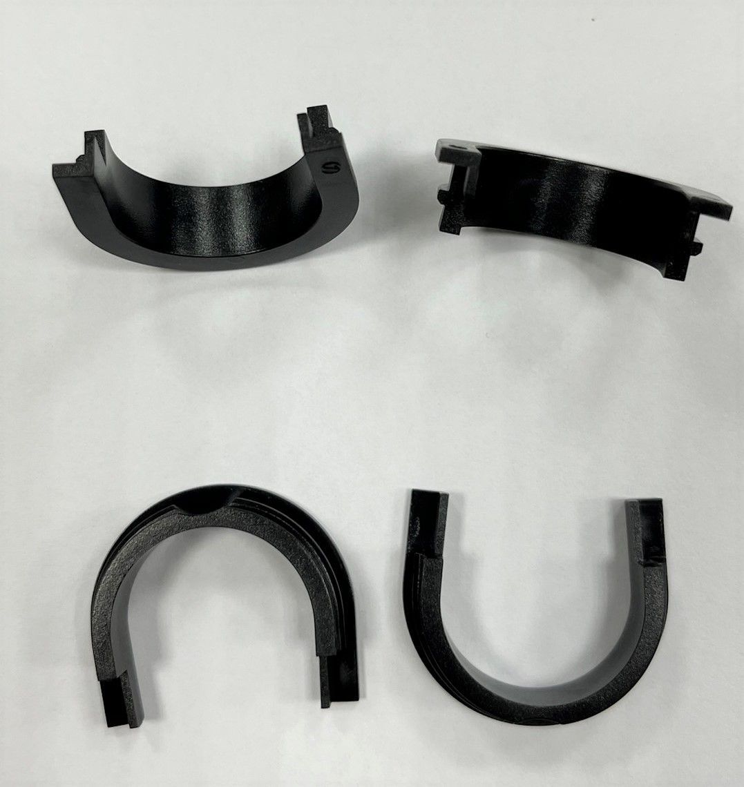 Three black plastic rings with the letter u on them