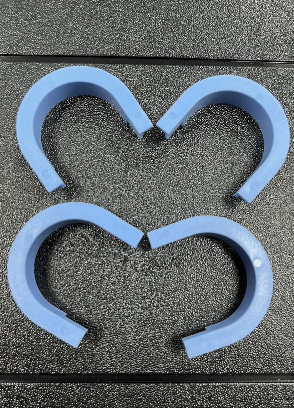 A pair of blue horseshoes in the shape of a heart.