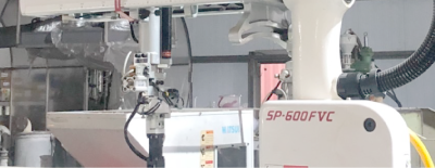 A white robotic arm is sitting on a table in a room.