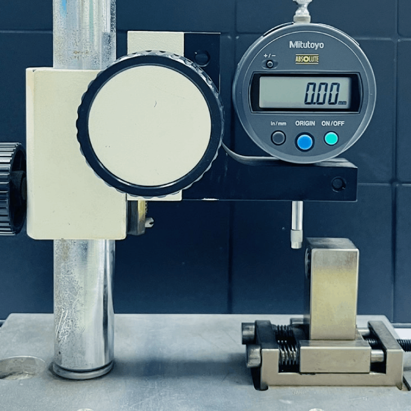 A mitutoyo digital measuring device is sitting on a table