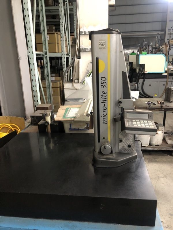 A machine is sitting on top of a table in a warehouse.