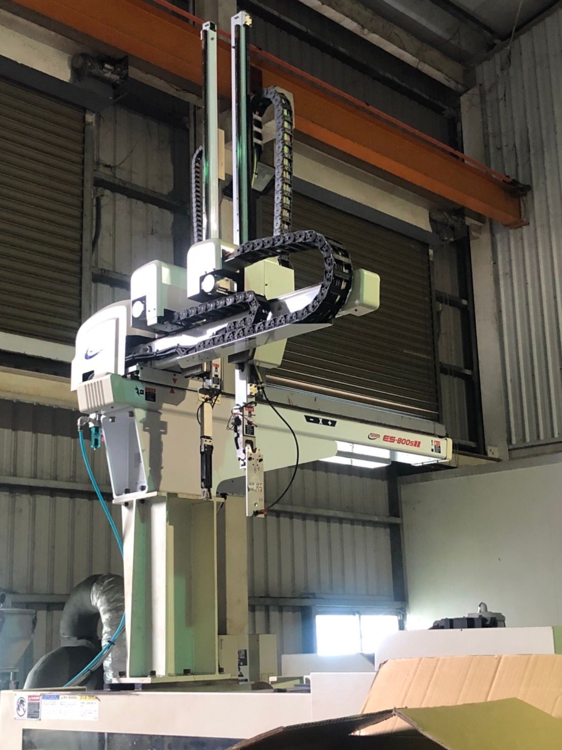 A machine is hanging from the ceiling of a building.