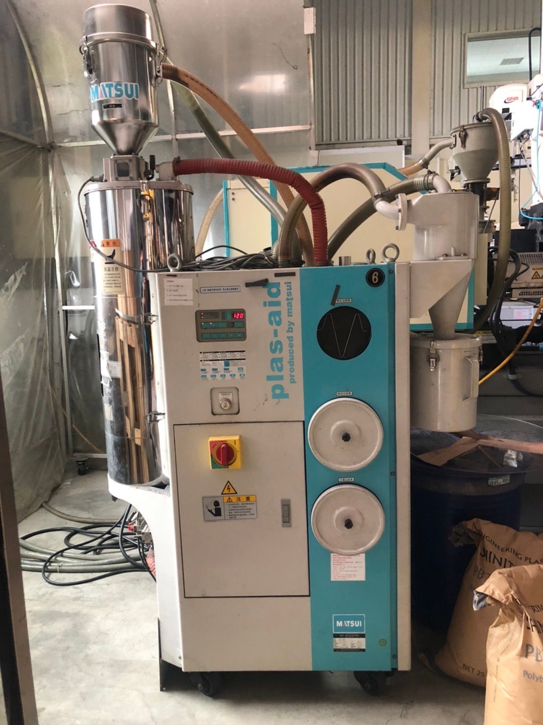 A machine is sitting in a room in a factory.