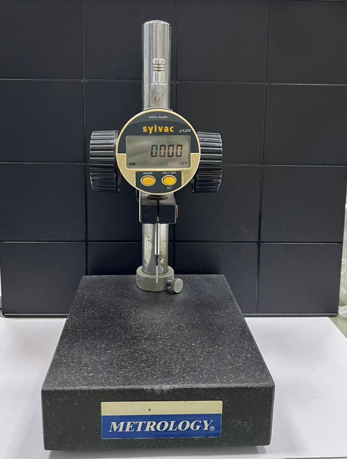 A measuring device that says metrology on it