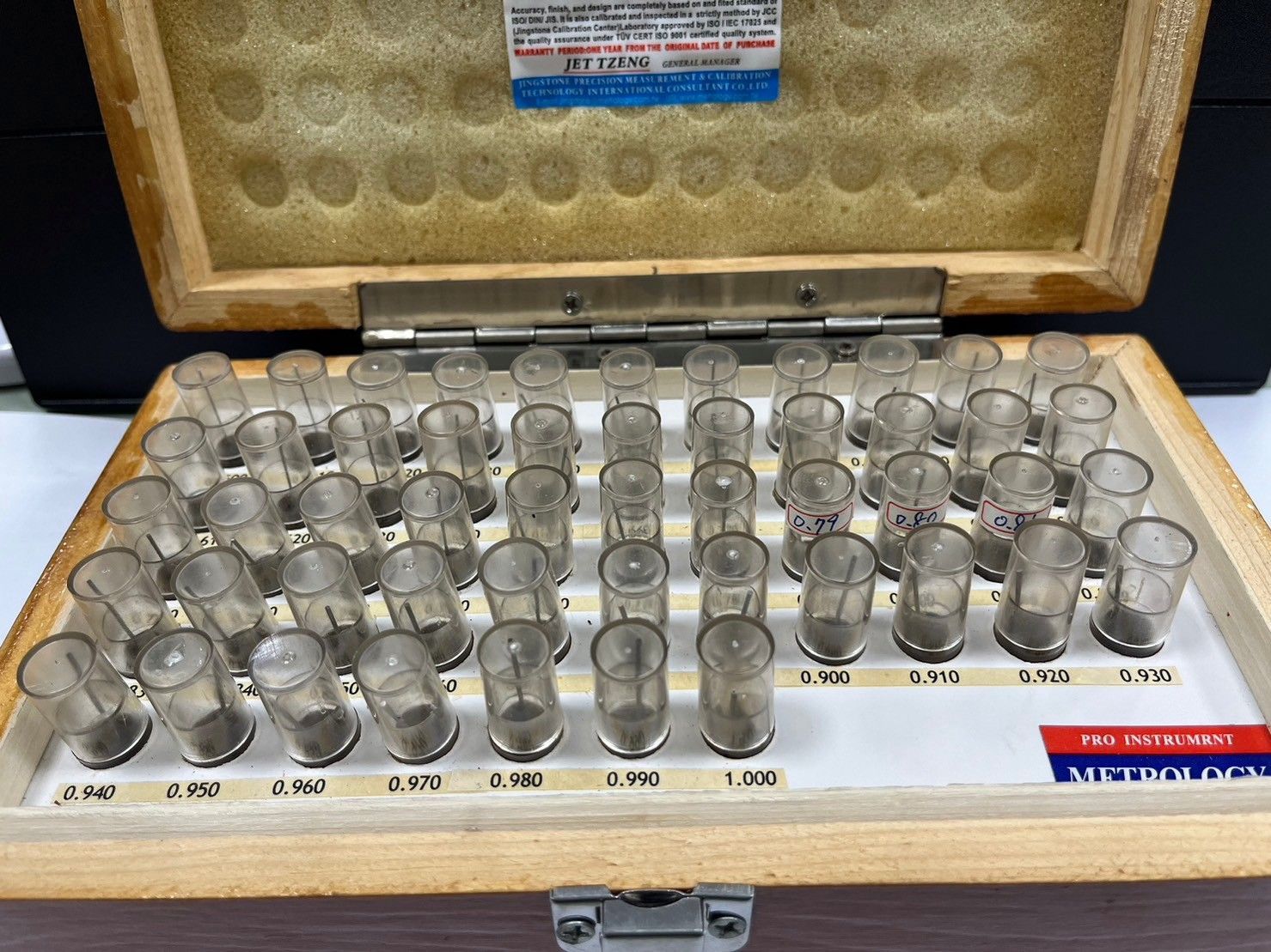 A wooden box filled with a bunch of clear containers.