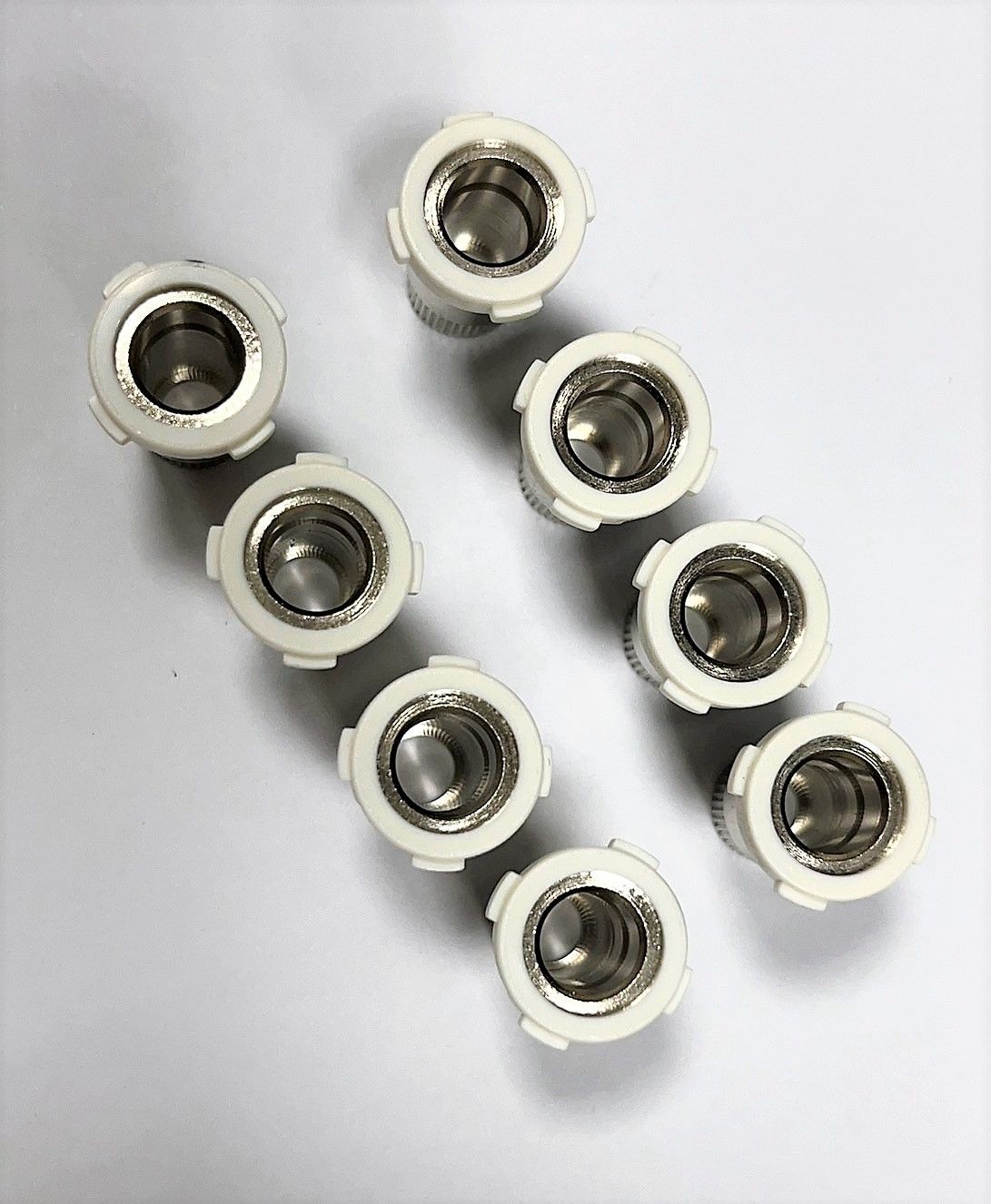 A bunch of holes in a row on a white surface.