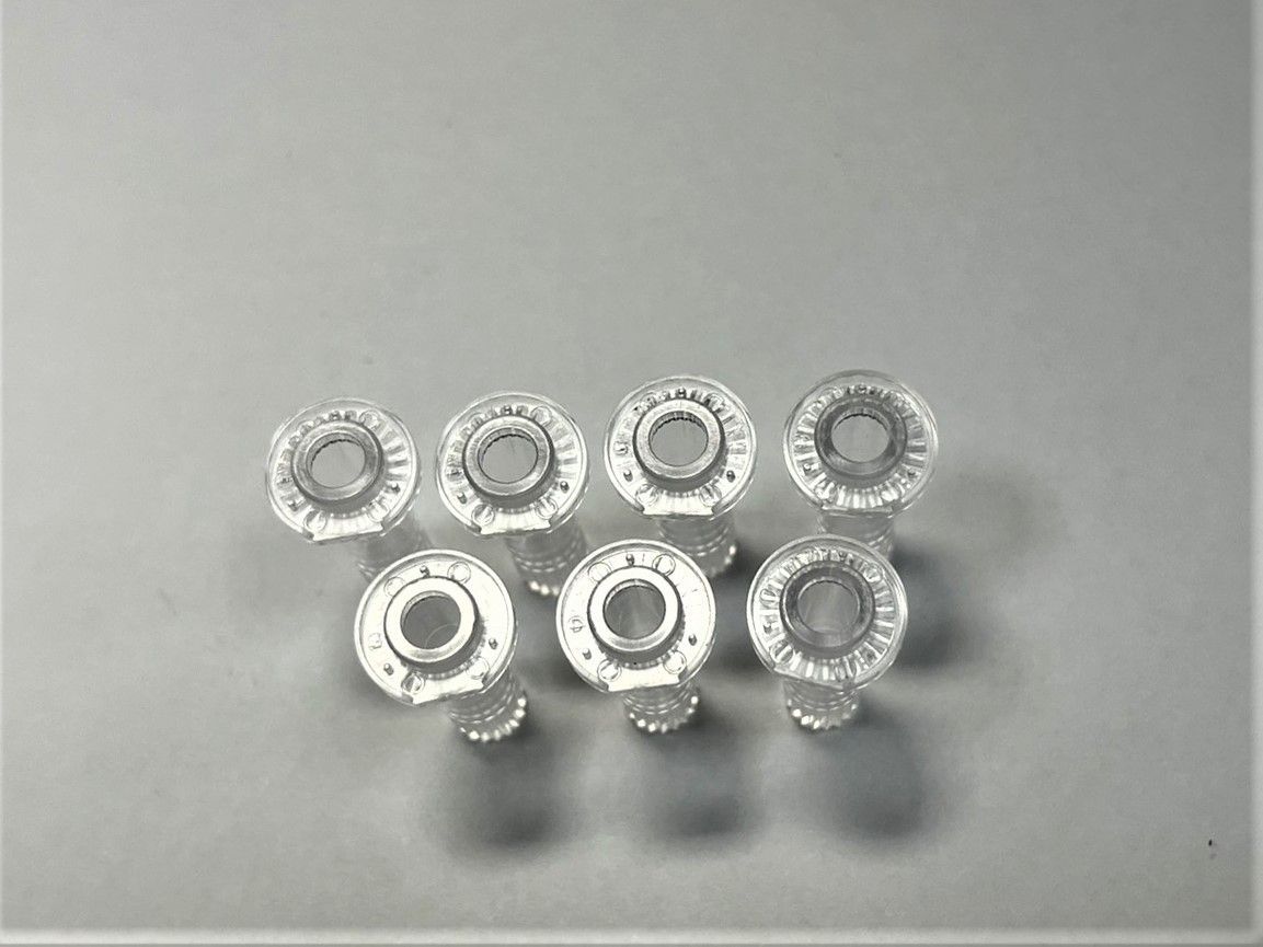 A group of clear plastic rings are sitting on top of each other on a table.