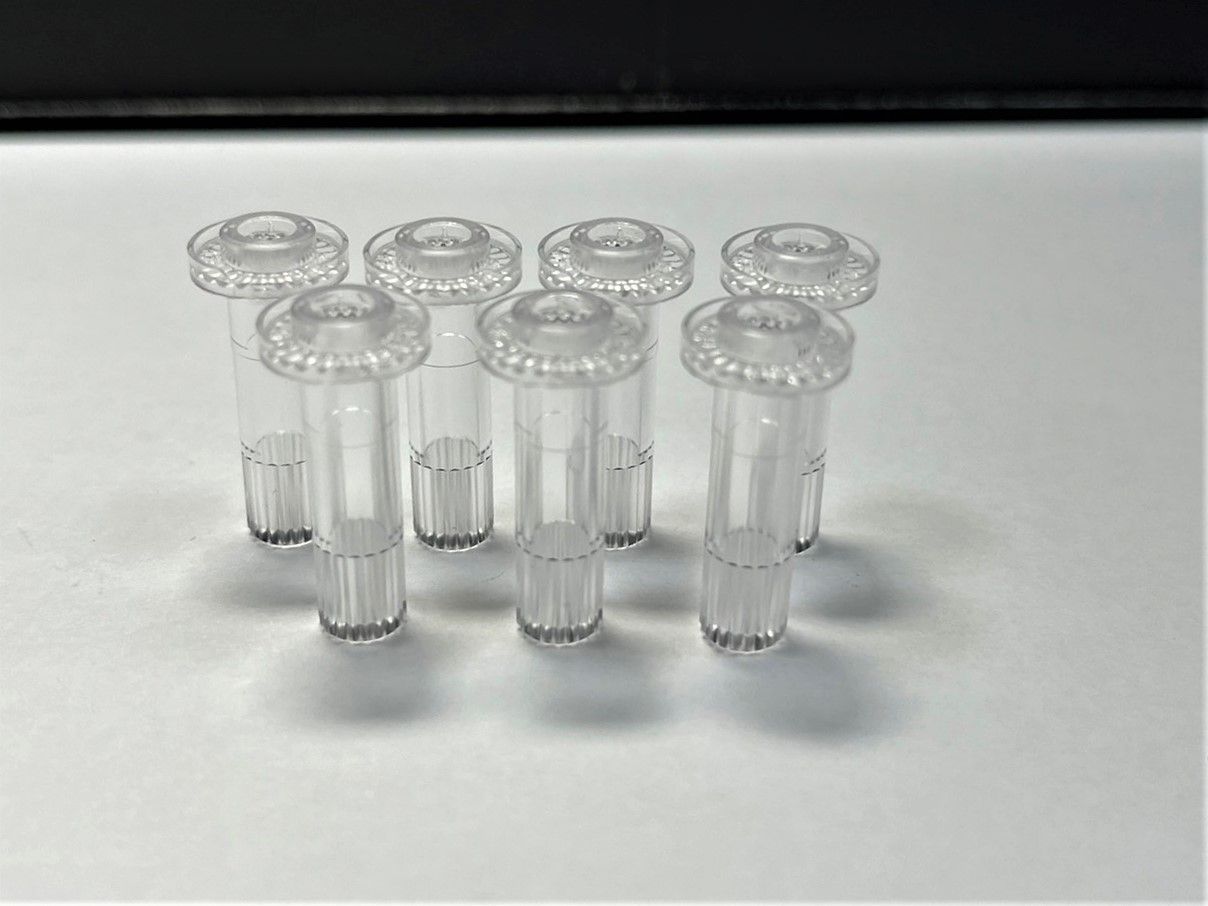 A group of clear plastic tubes sitting on top of a white table.