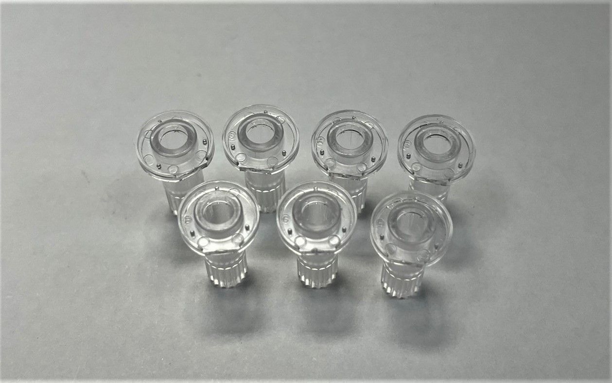A group of clear glass knobs are sitting on a table.