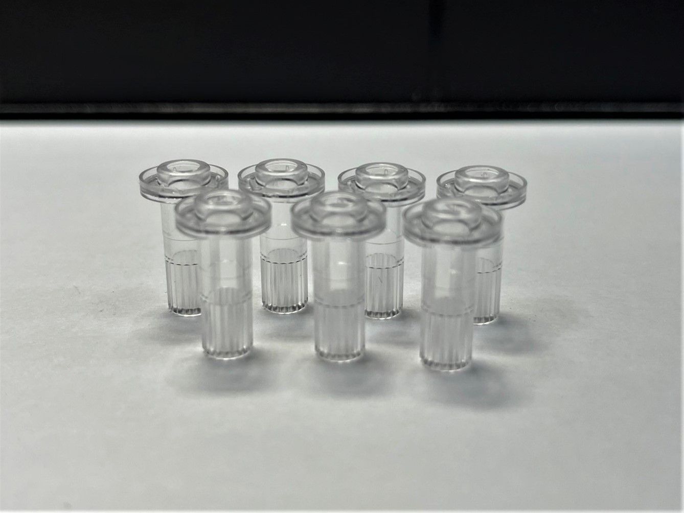 A group of clear plastic tubes sitting on top of a white table.
