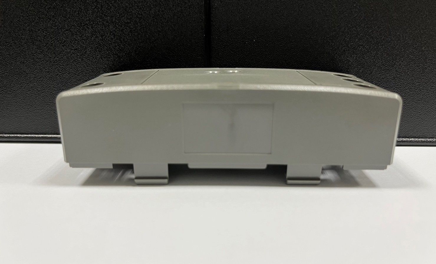 A gray box is sitting on top of a white table.