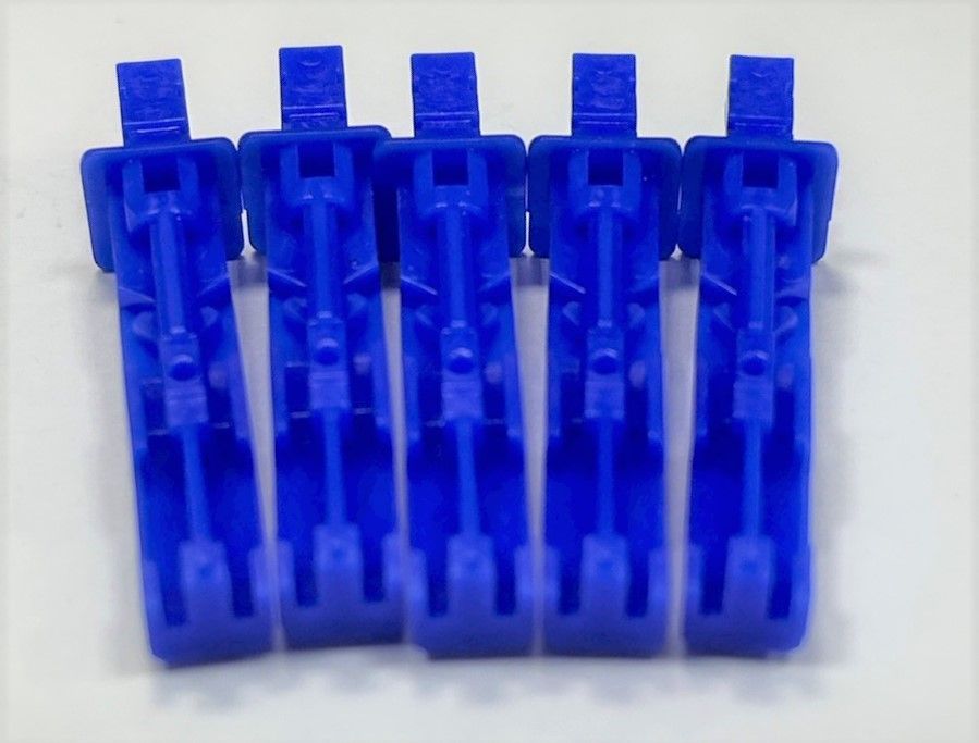A row of blue plastic clips on a white surface