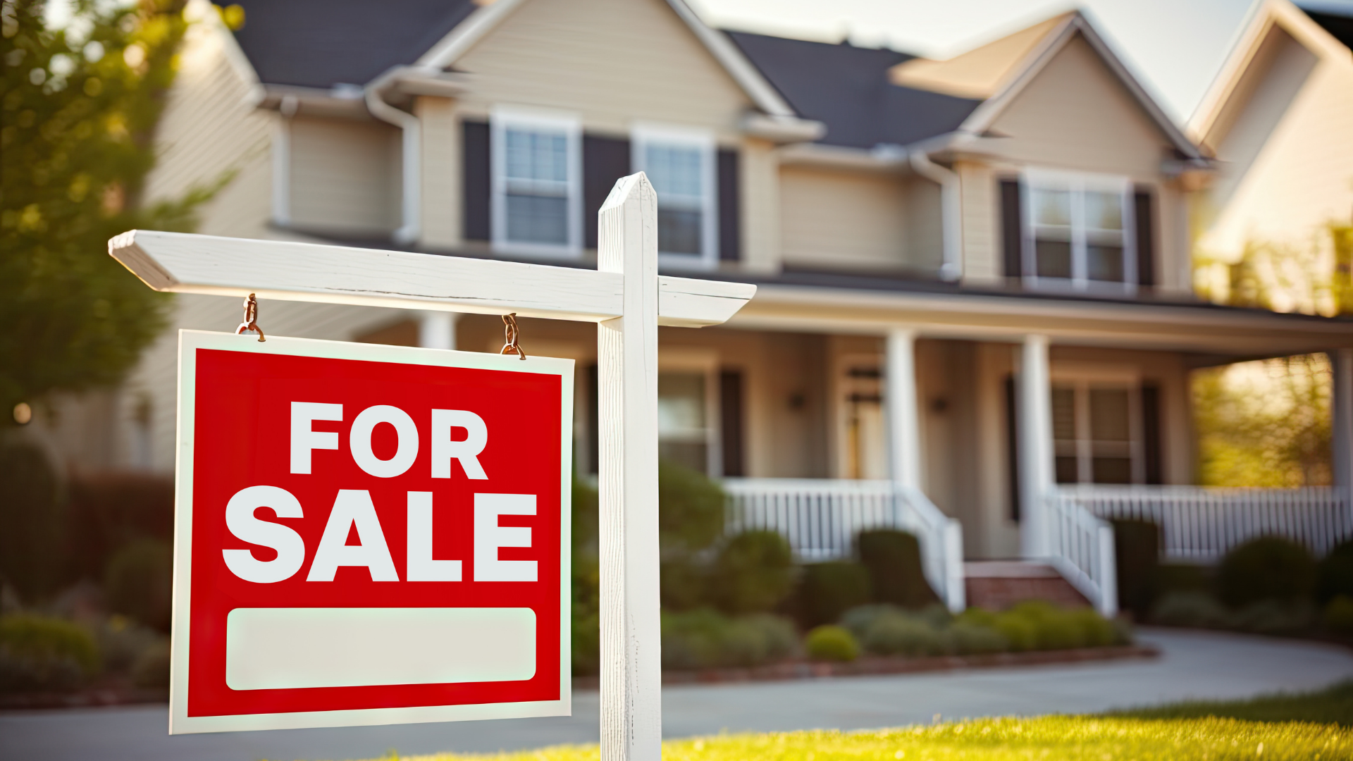 A for sale sign is in front of a house.