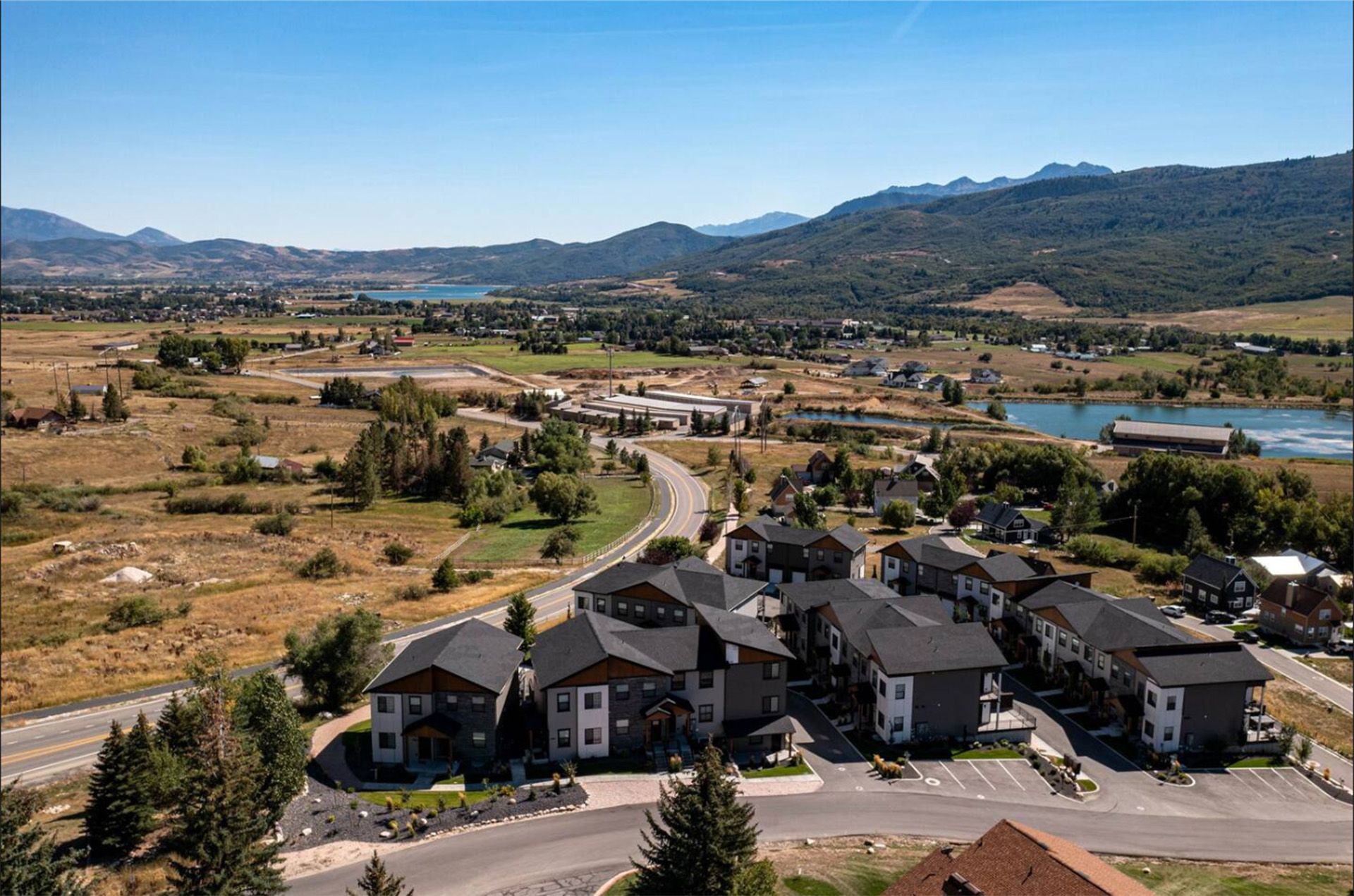 An aerial view of the Peaks development area with mountains in the background.