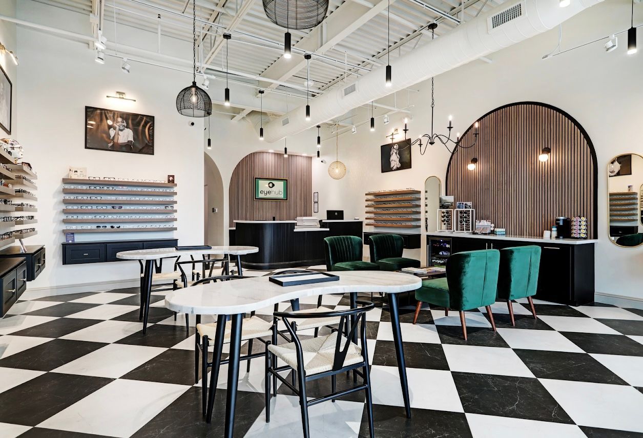 Optical shop interior with checkered floor, eyewear displays, and seating.