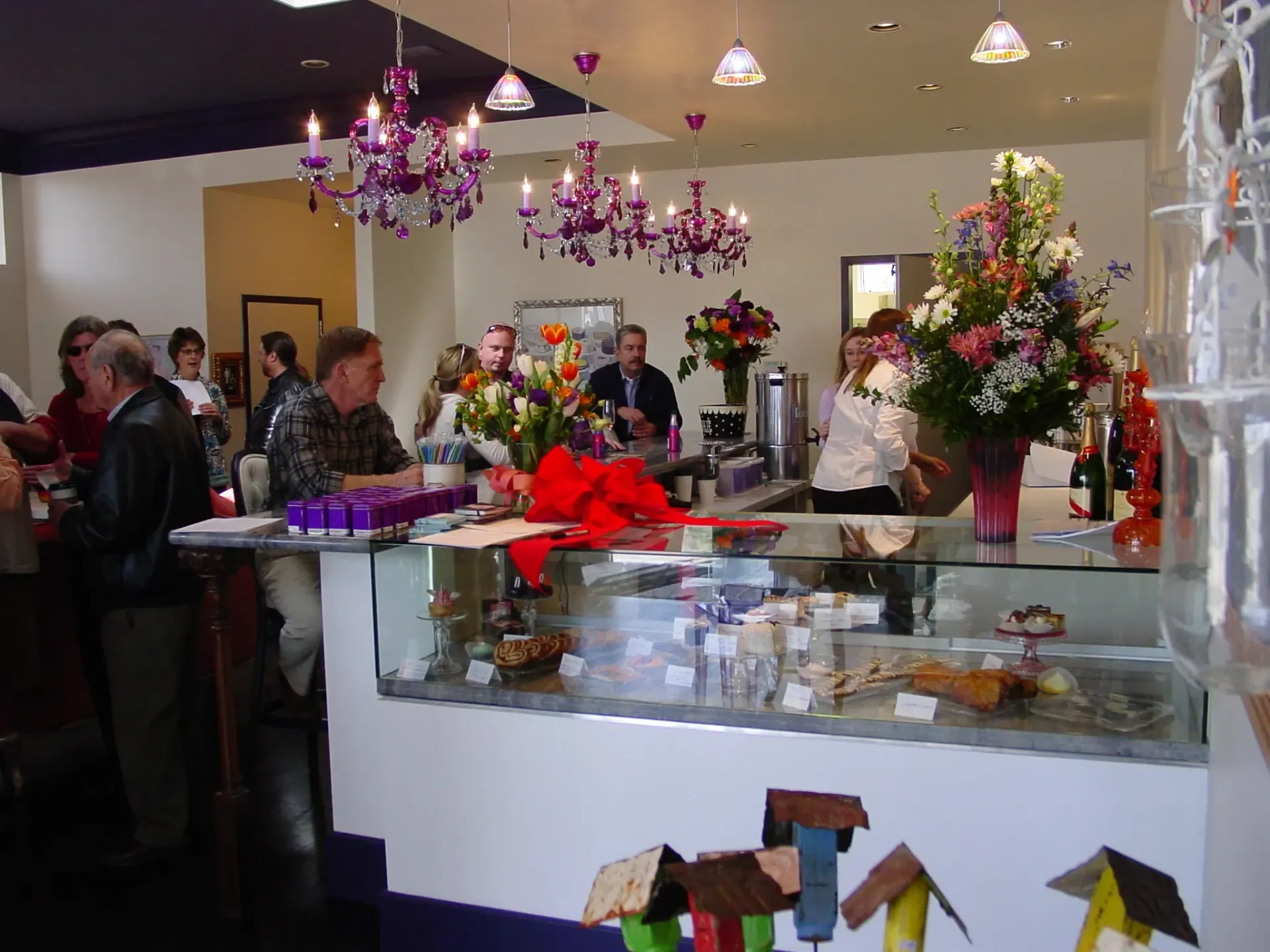 A group of people are gathered around a counter in a restaurant