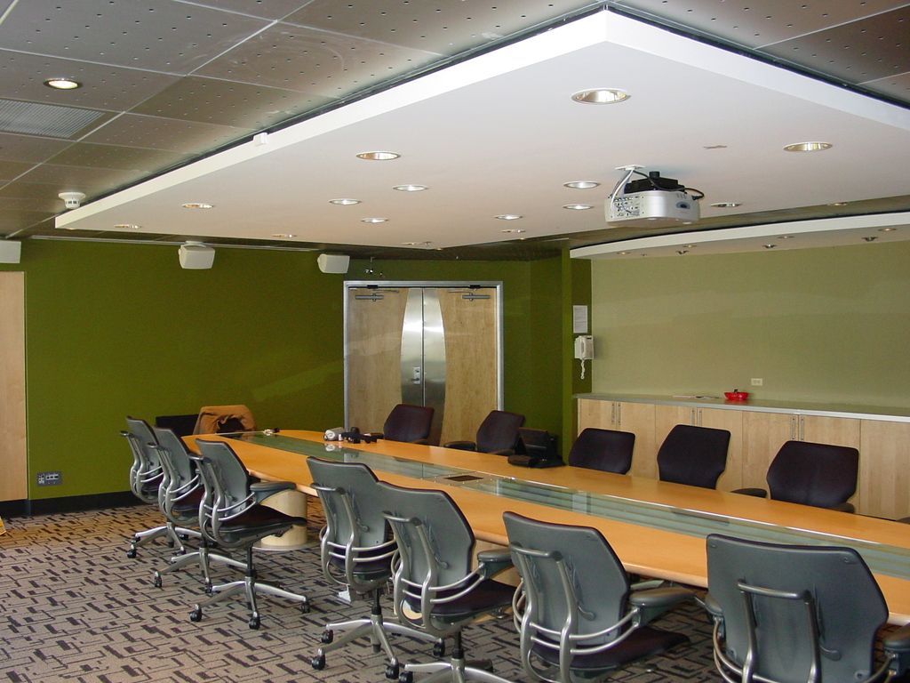 A conference room with a long table and chairs