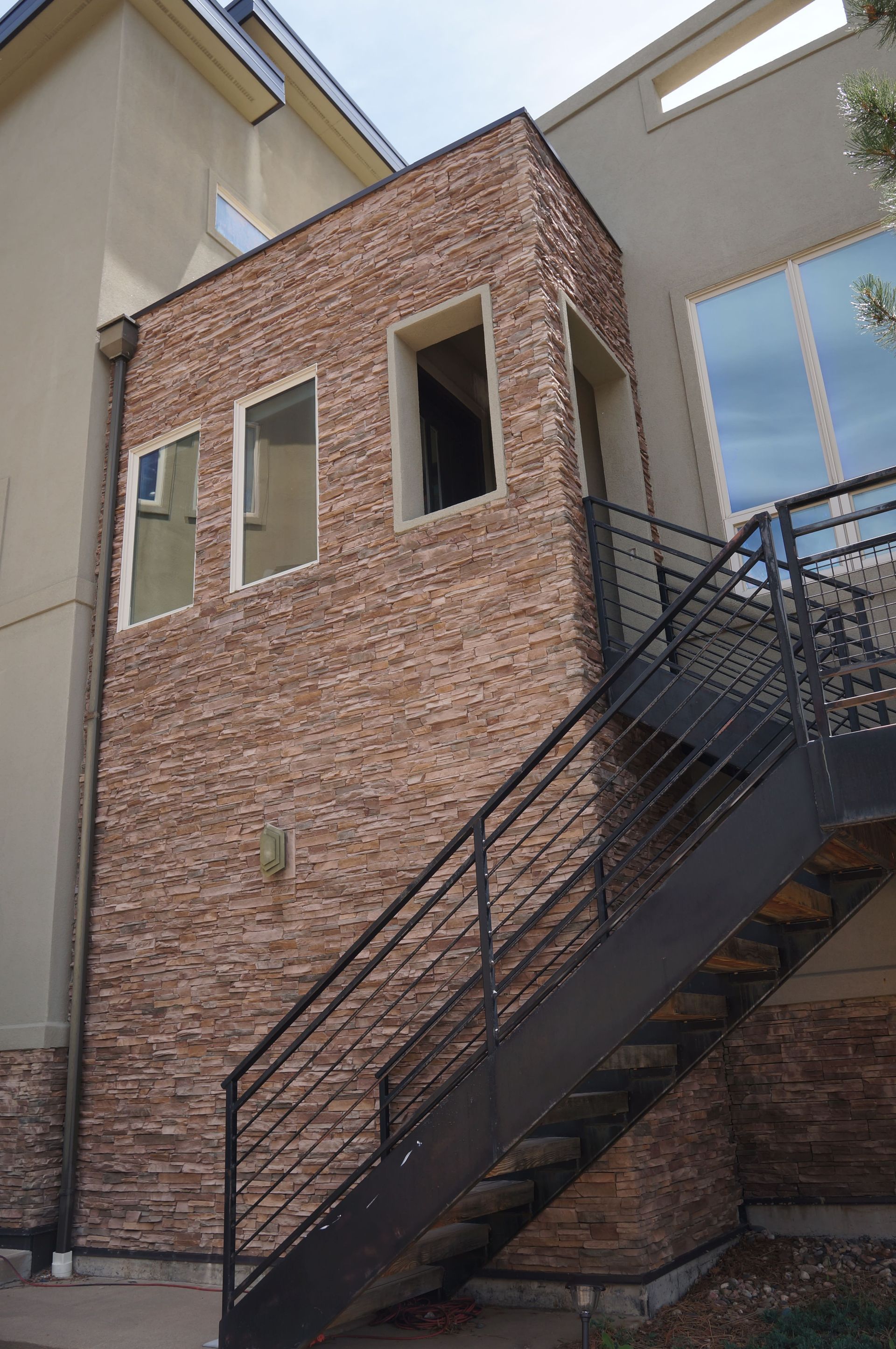 A brick building with stairs leading up to it