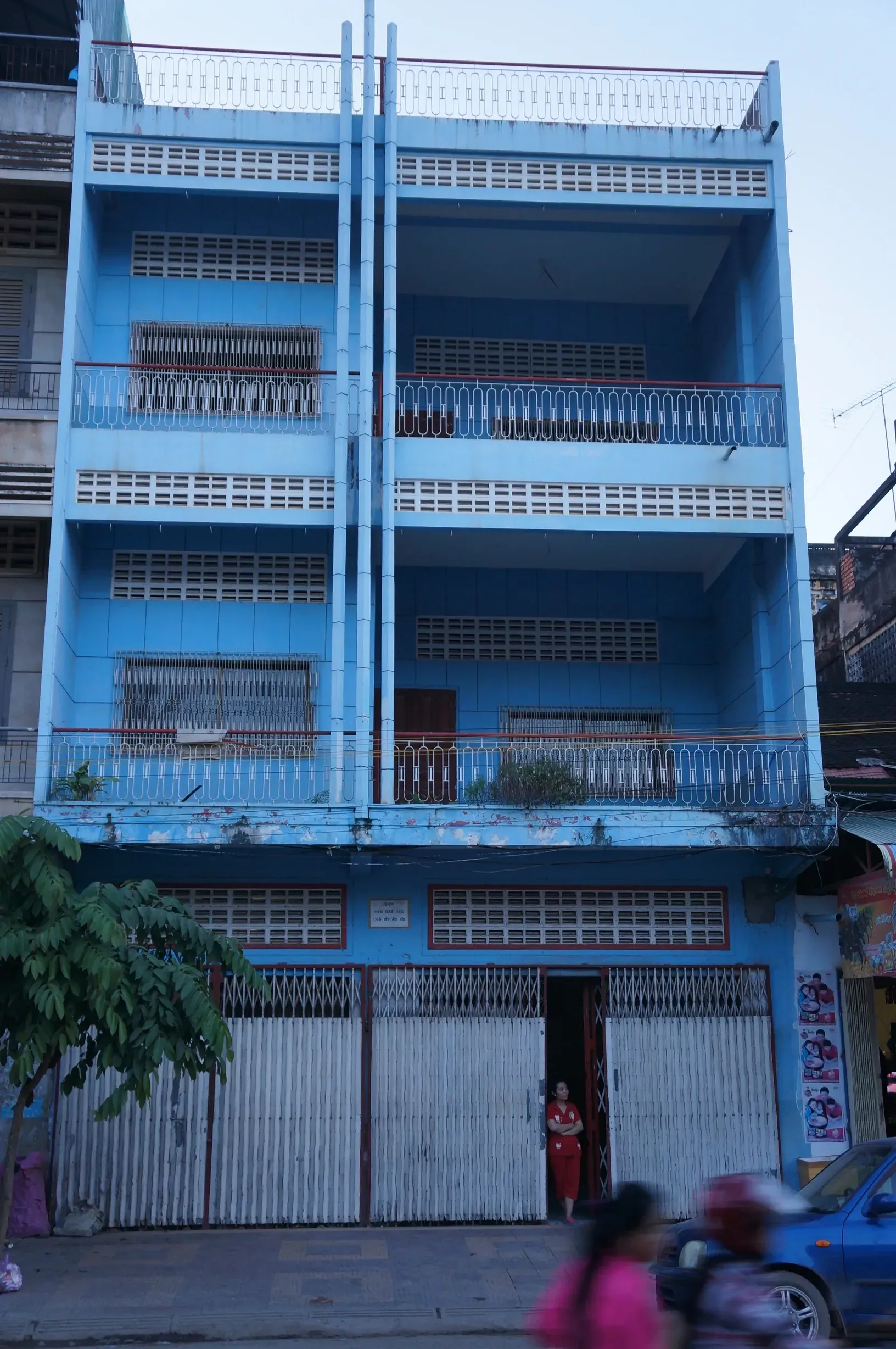 A blue building with a lot of windows and balconies
