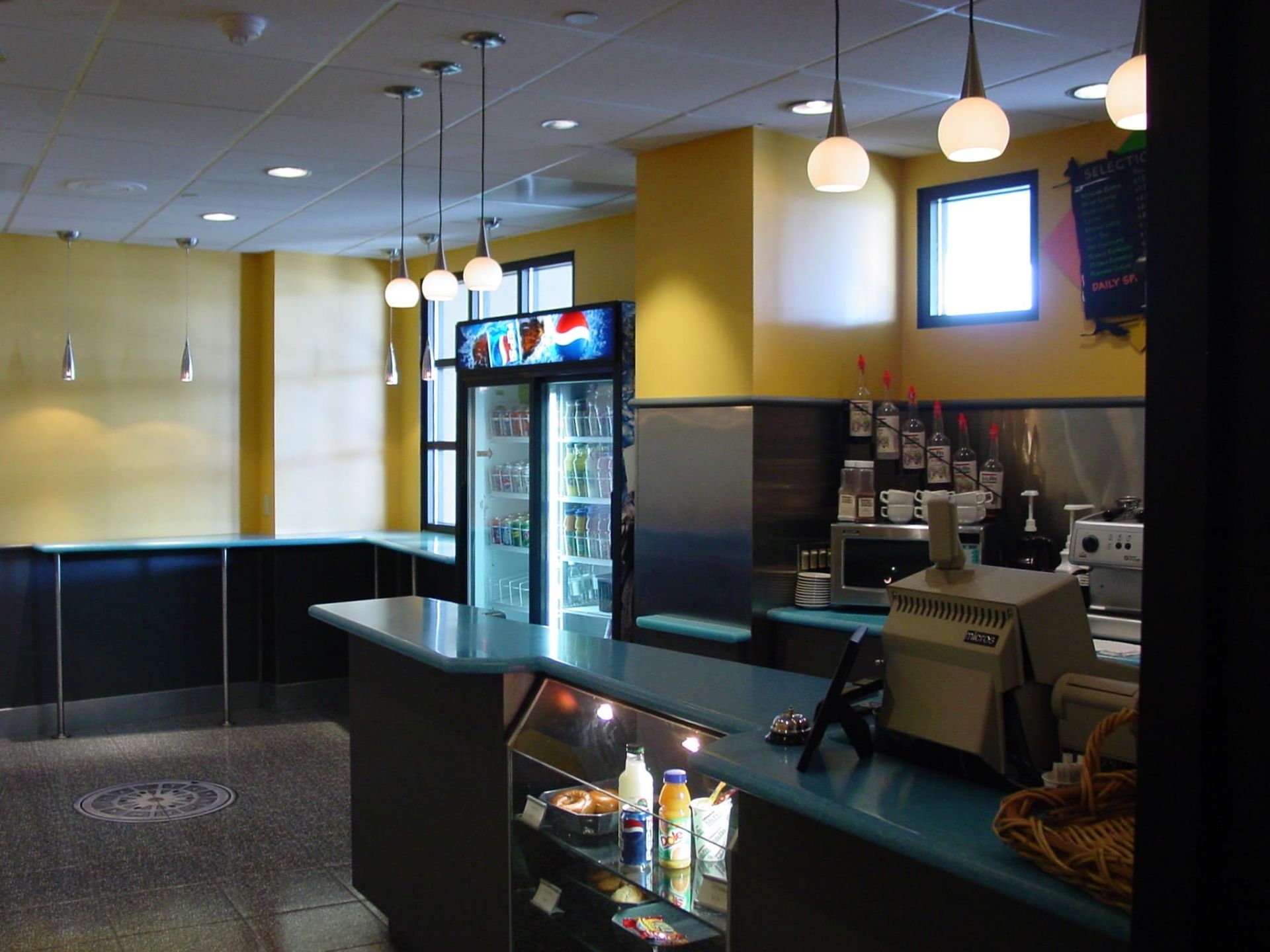 A pepsi fridge sits in the middle of a restaurant