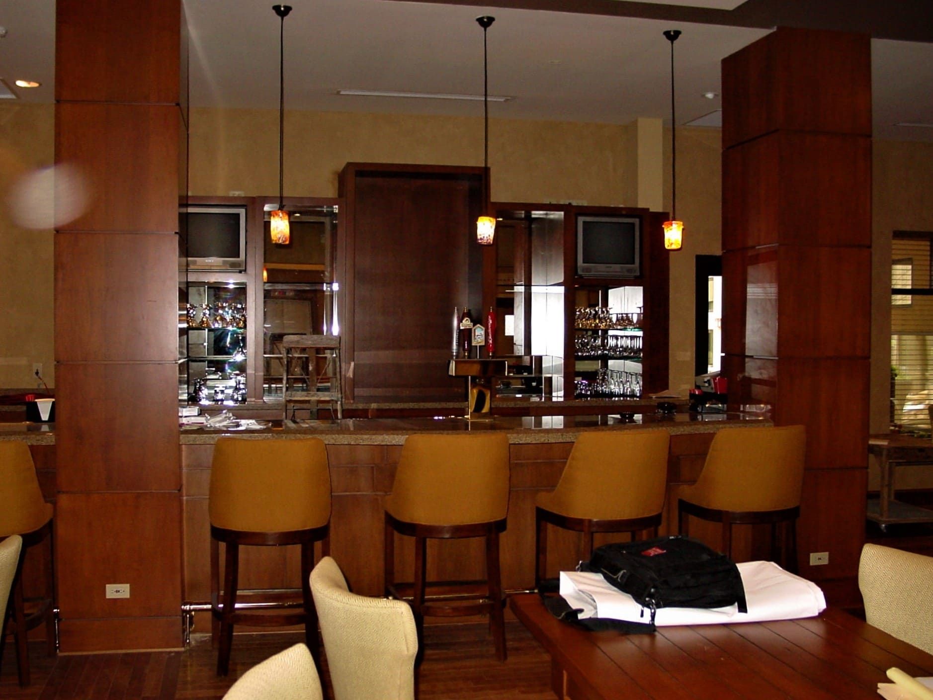 A room with a table and chairs and a bar