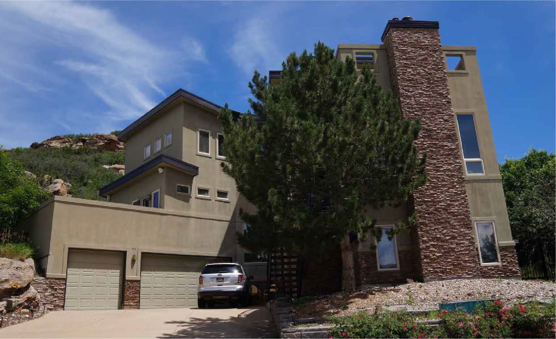 A large house with a car parked in front of it