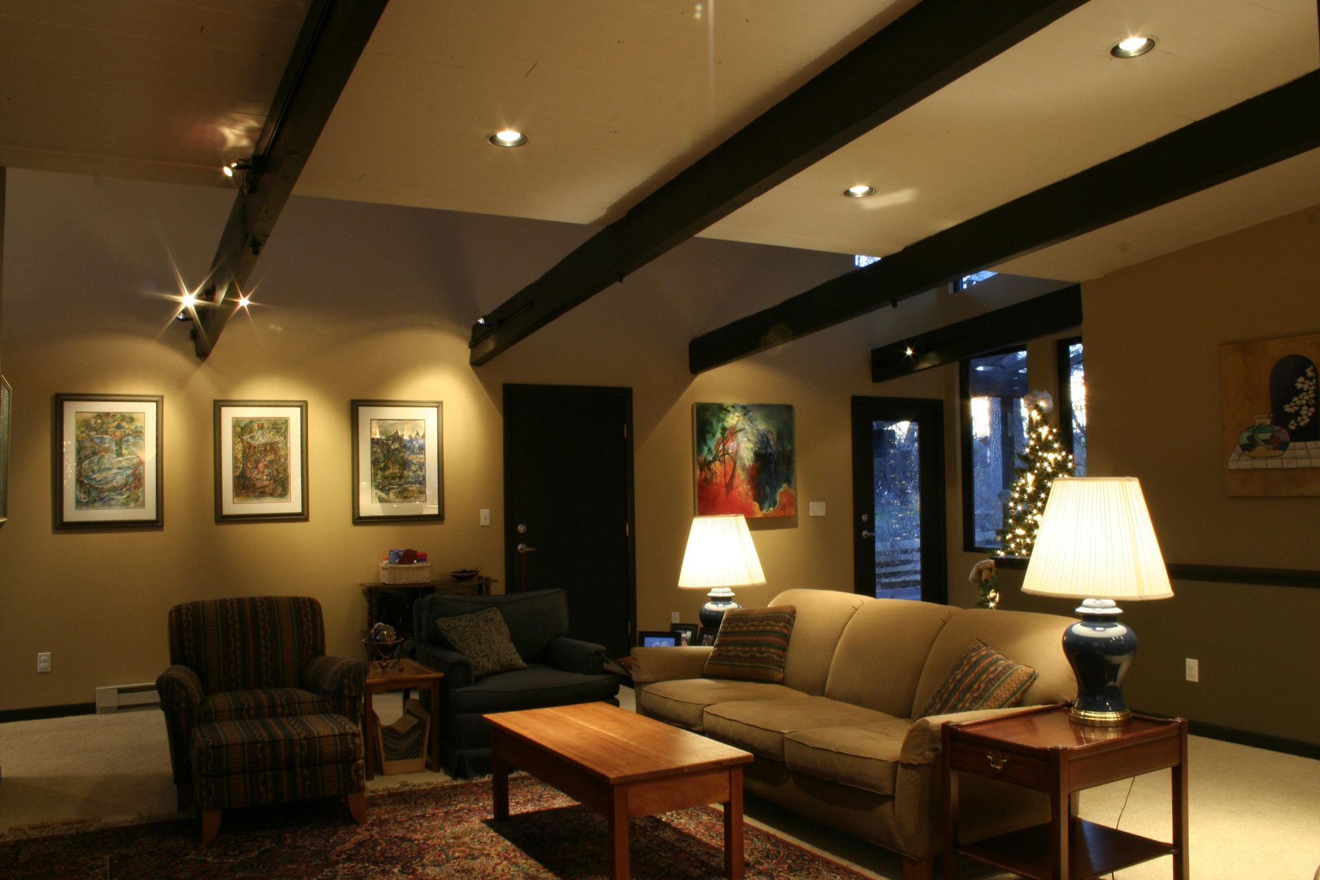 A living room with a couch and chairs and lamps