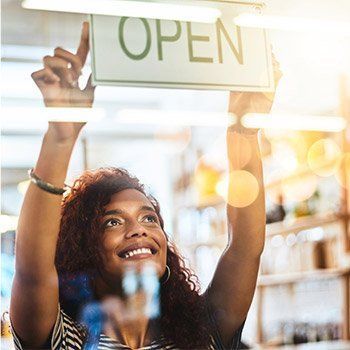 A woman holding a sign — Thryv Foundation