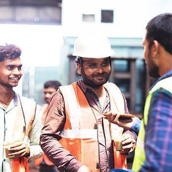 A man wearing safety vests and helmets — Thryv Foundation