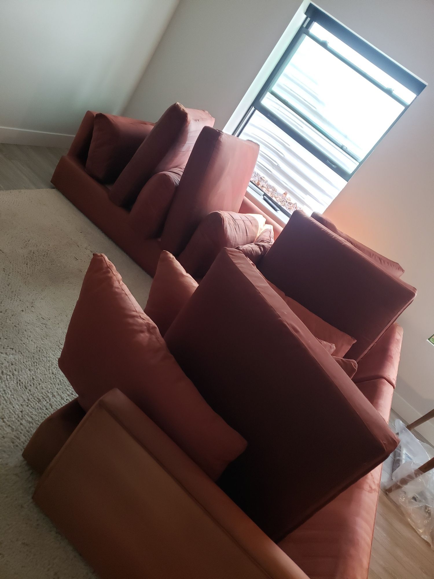 A living room with a couch and chairs in front of a window