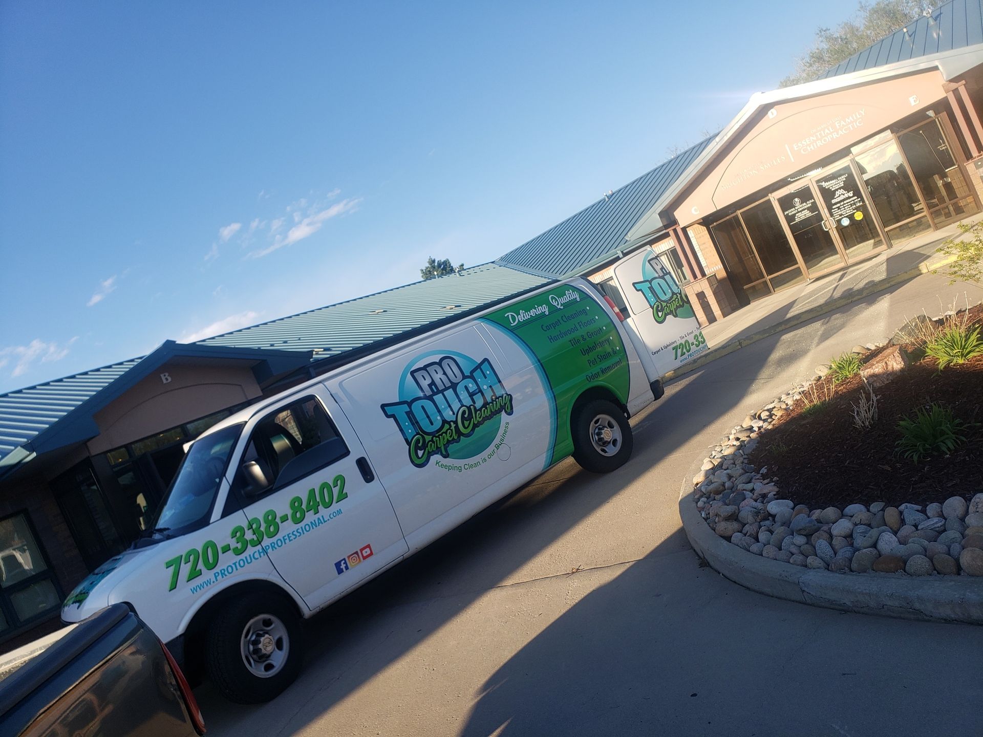 A tough guys van is parked in front of a building