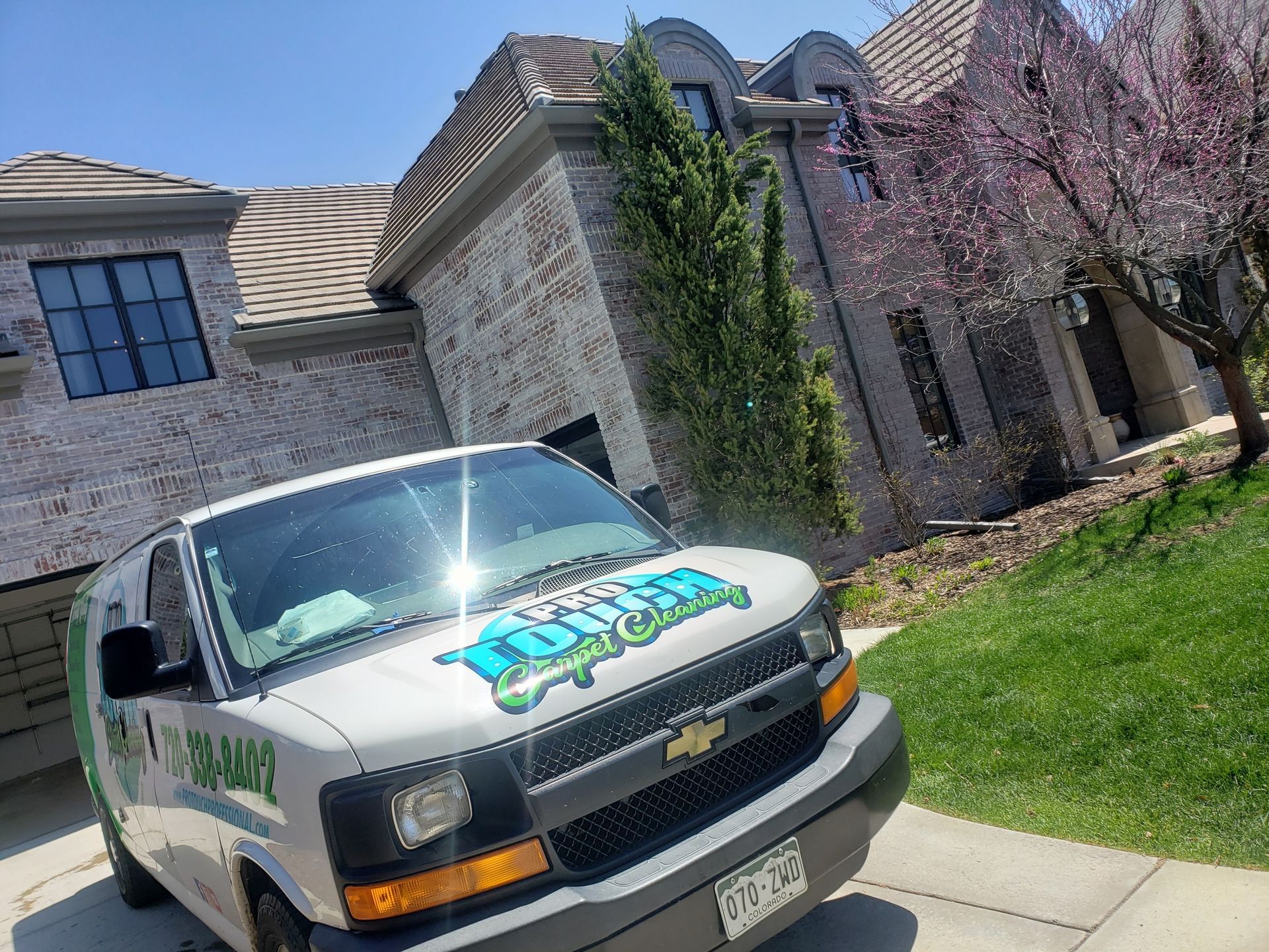 A white van is parked in front of a house.
