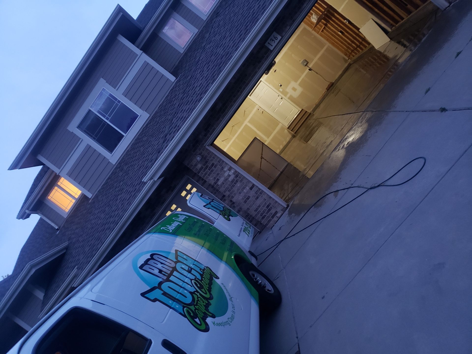 A white van is parked in front of a house.