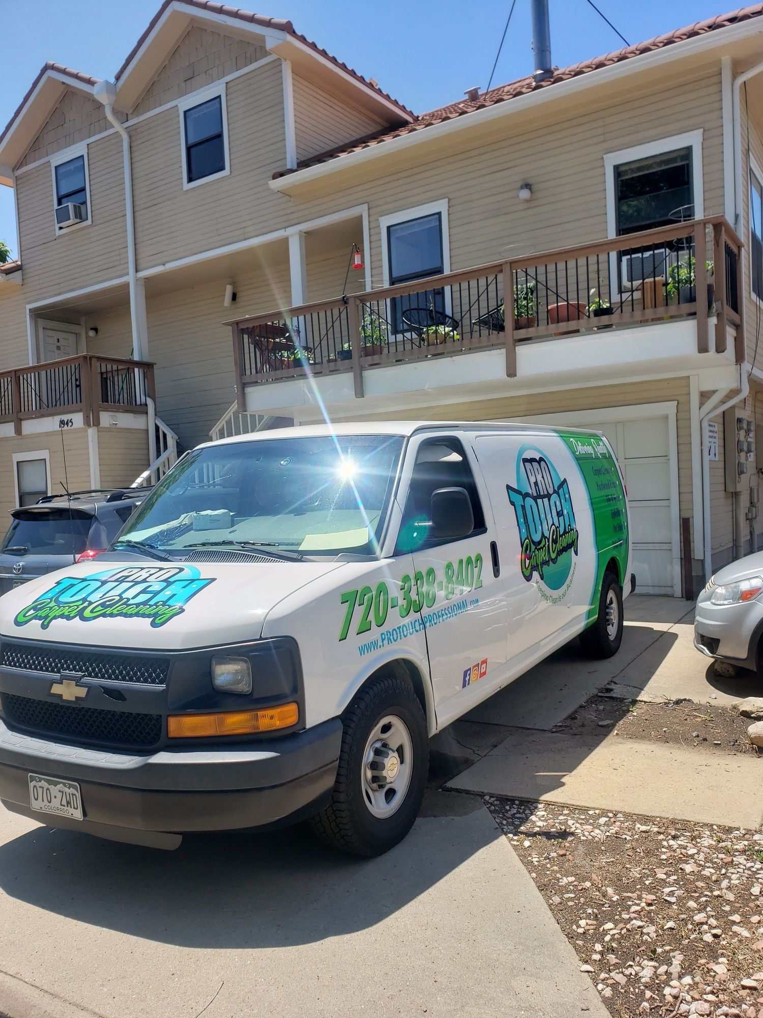 A white van is parked in front of a house.