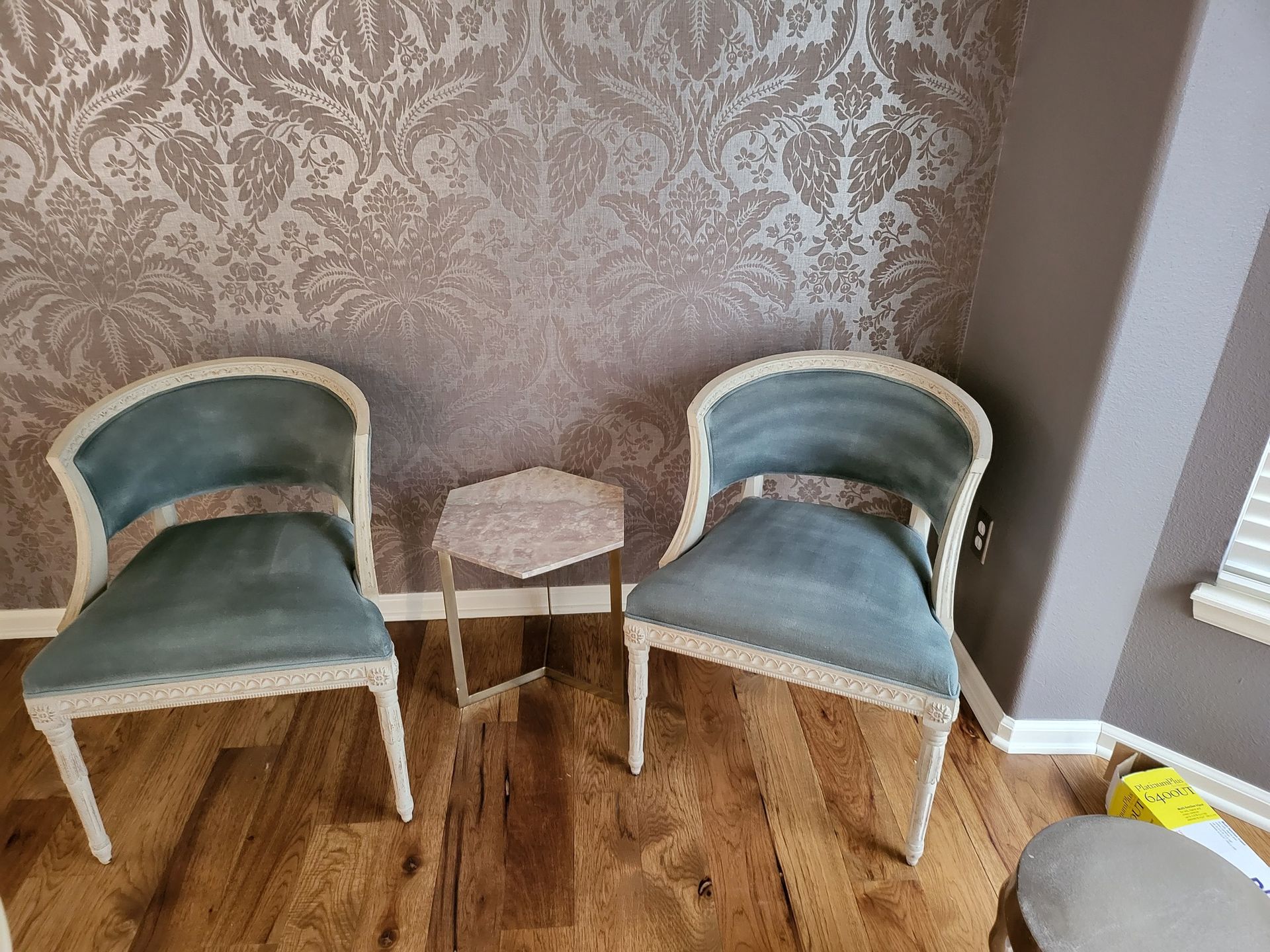 Two chairs and a small table in a living room.