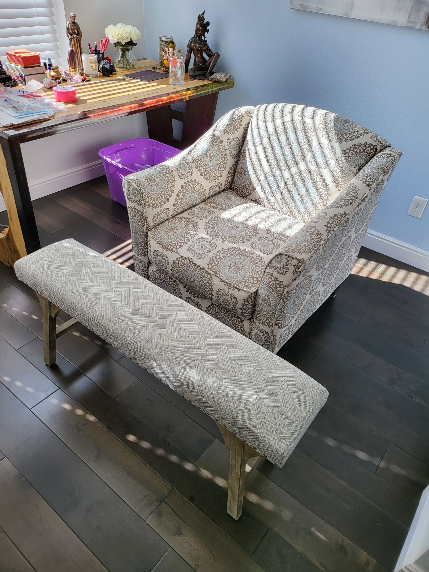 There is a chair and a bench in the room.