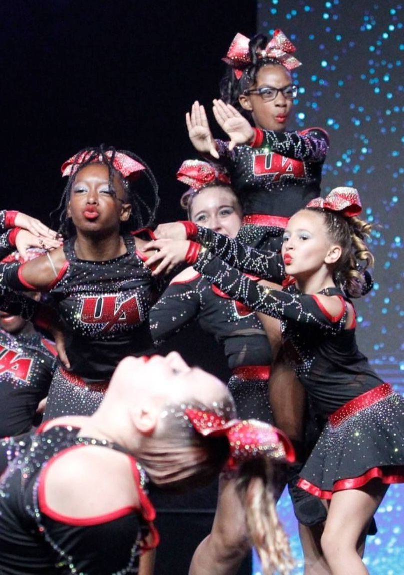A group of cheerleaders are performing on a stage.