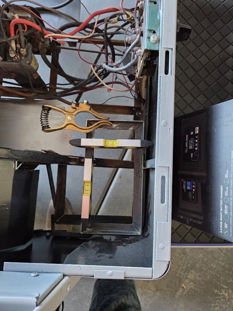 Inside of equipment, a level is attached, along with a tool for measuring and wires.