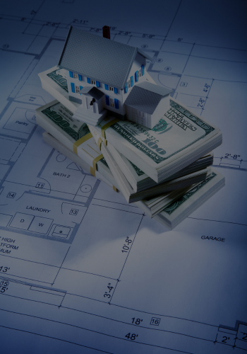 Model house atop money stacks on architectural blueprints.