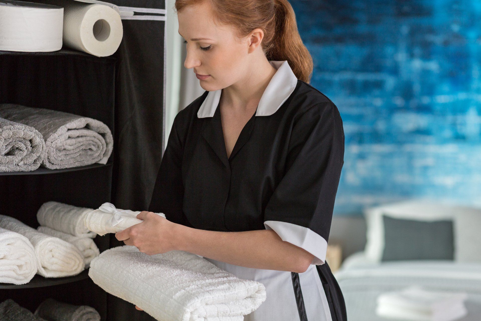 Women Organizing towels — Medford, OR — Rogue Valley Maids