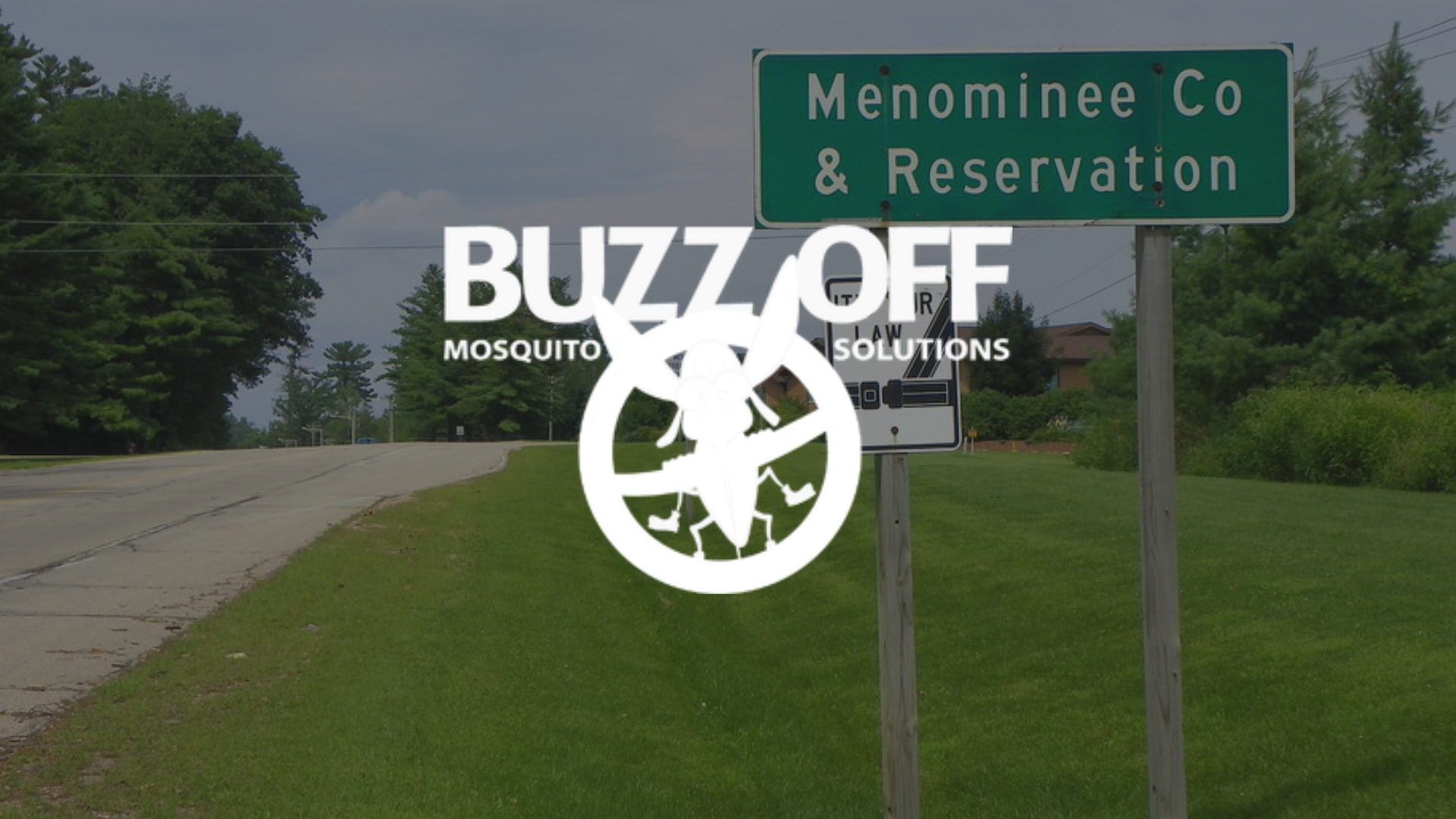 The logo for buzz off mosquito solutions is on a patio with a table and chairs.