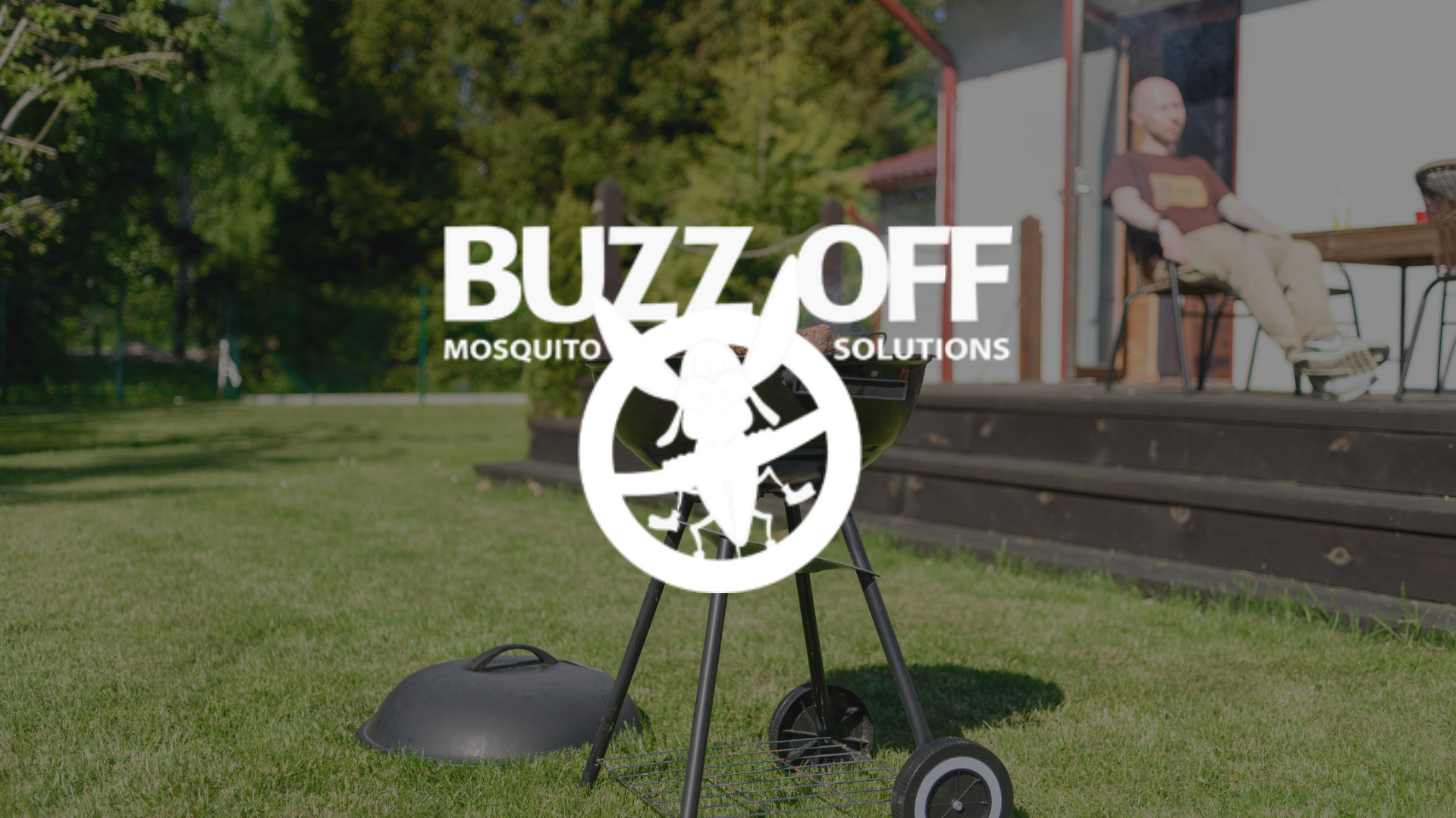 The logo for buzz off mosquito solutions is on a patio with a table and chairs.