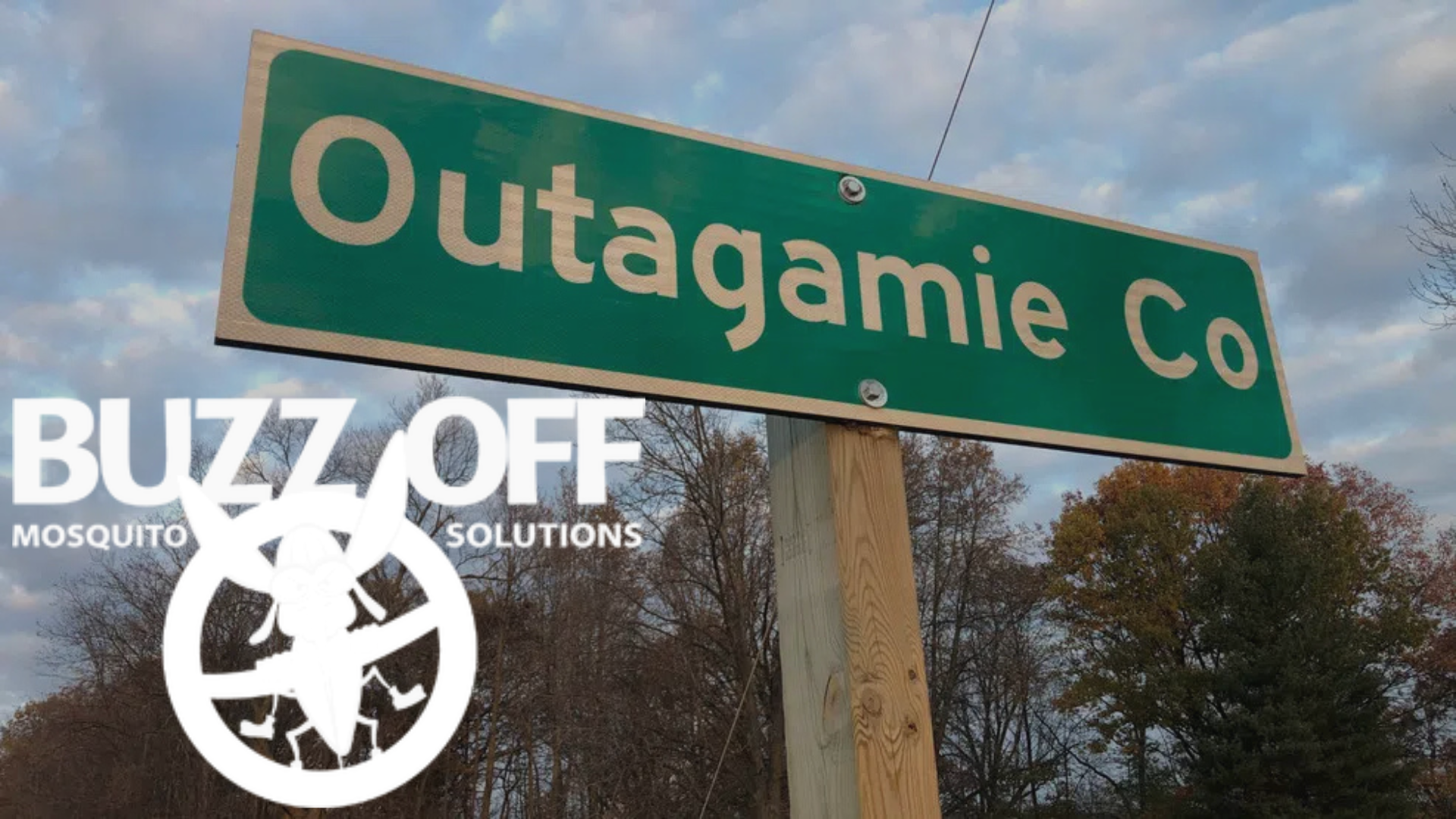 A green street sign that says outagamie co.