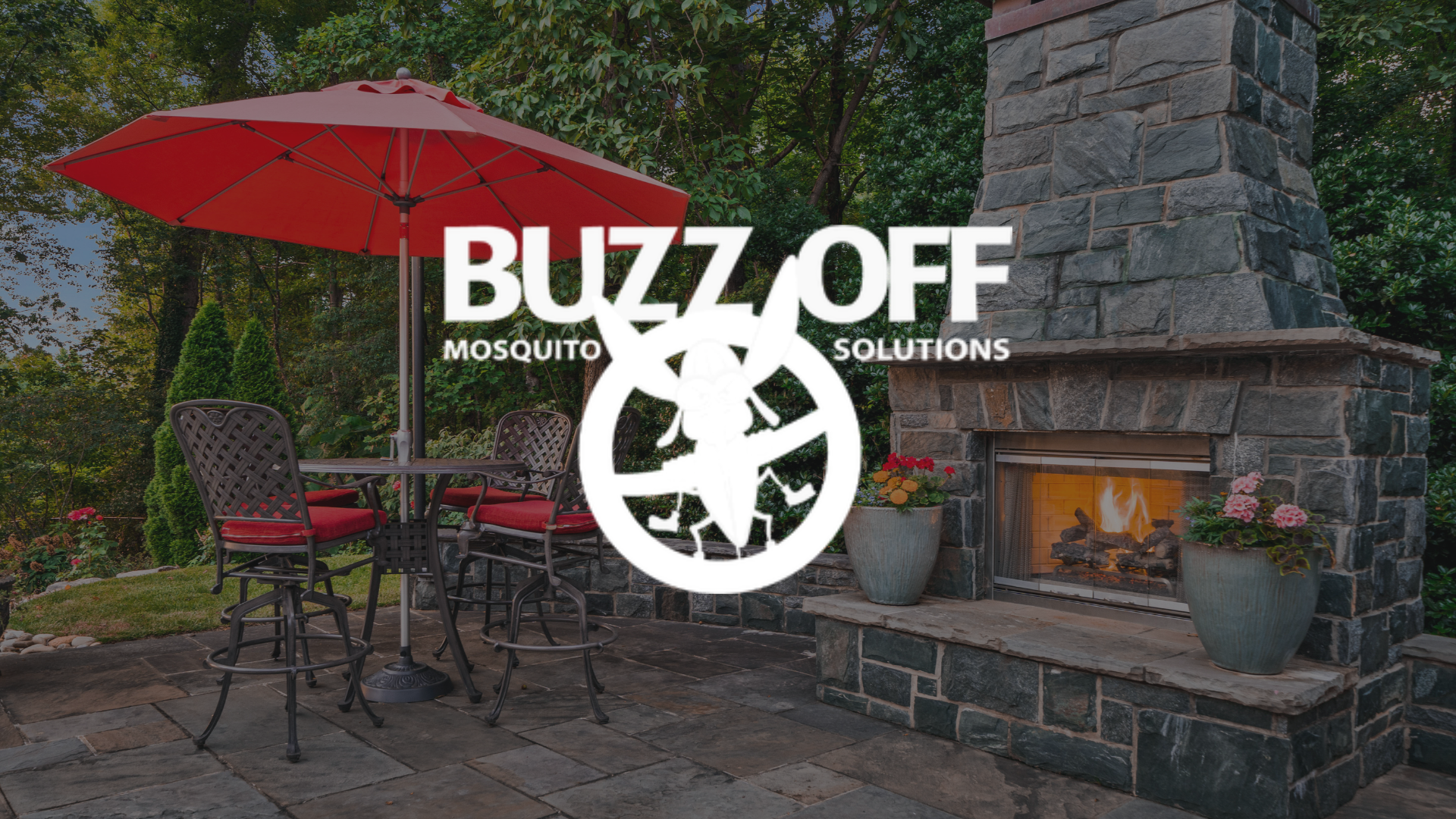 The logo for buzz off mosquito solutions is on a patio with a fireplace and umbrella.