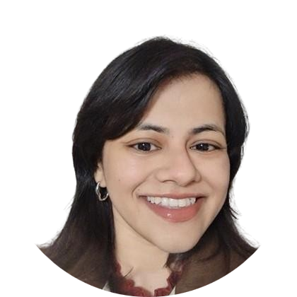 Smiling person with dark hair, brown eyes, wearing hoop earrings, and a brown jacket.