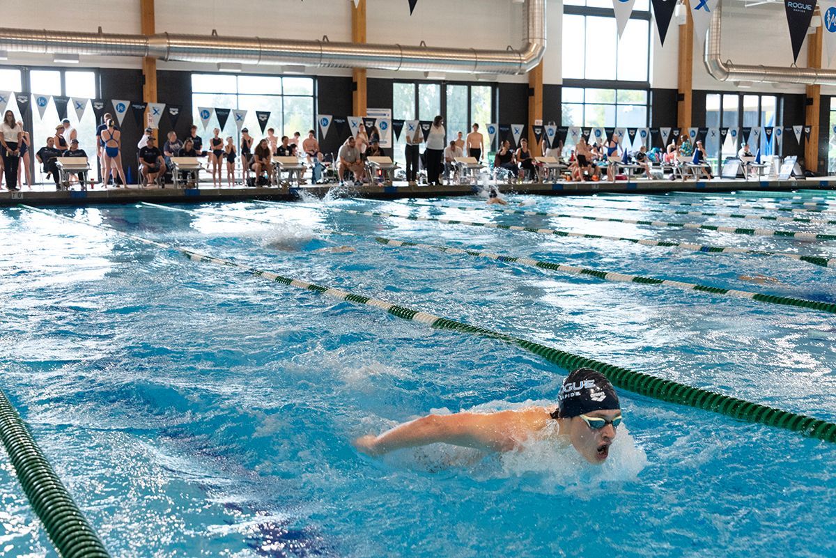 people are swimming in a pool with red white and blue lanes